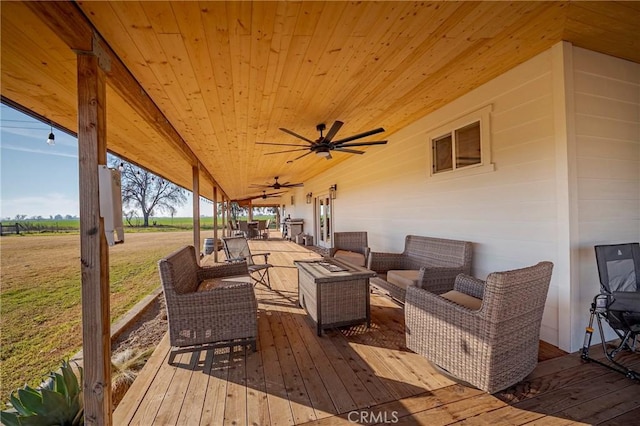 wooden deck with ceiling fan and an outdoor hangout area