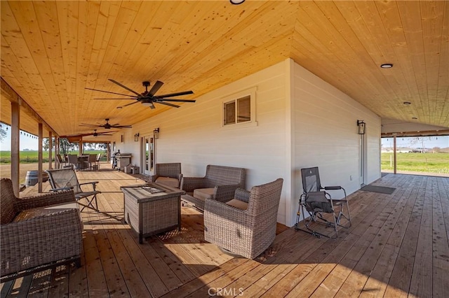 deck featuring ceiling fan and outdoor lounge area