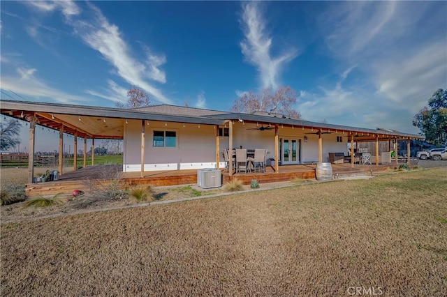 view of front facade with a patio area, a front lawn, and central air condition unit