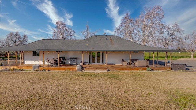 rear view of property with a patio area, a yard, and french doors