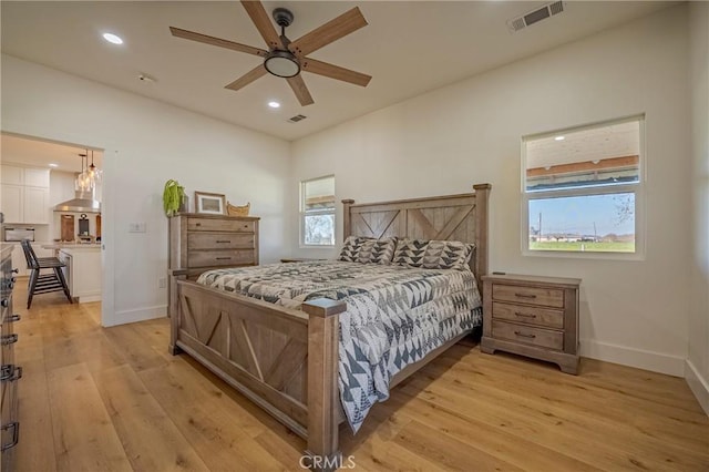 bedroom with ceiling fan and light hardwood / wood-style flooring