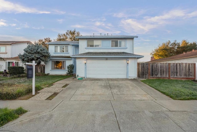 front facade with a garage and a front lawn