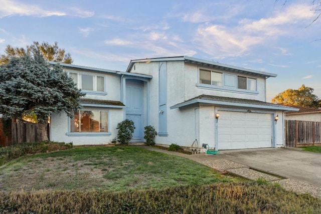 view of front property featuring a garage and a front lawn