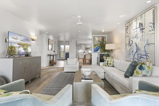 living room featuring light wood-type flooring and ceiling fan