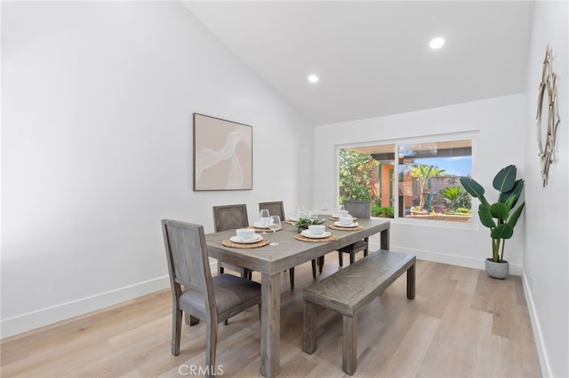 dining area featuring light hardwood / wood-style floors and lofted ceiling