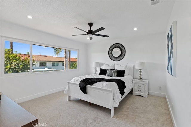 bedroom featuring ceiling fan and light carpet