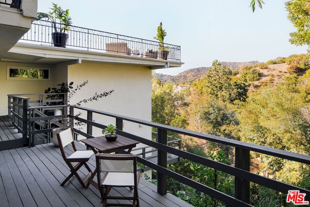 wooden terrace featuring a mountain view