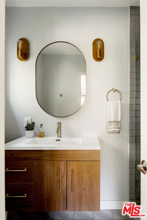 bathroom featuring tile patterned flooring and vanity