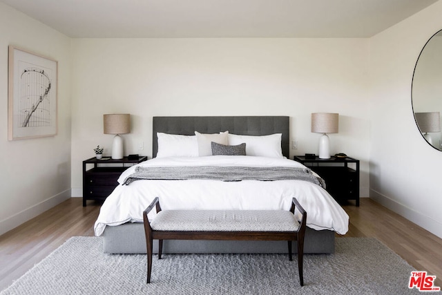 bedroom with hardwood / wood-style floors