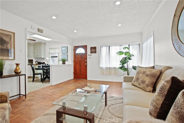 living room featuring crown molding, recessed lighting, baseboards, and a textured ceiling