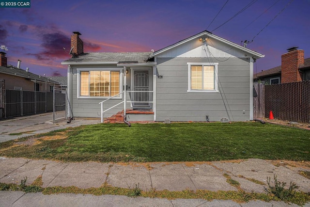 bungalow-style house with a yard