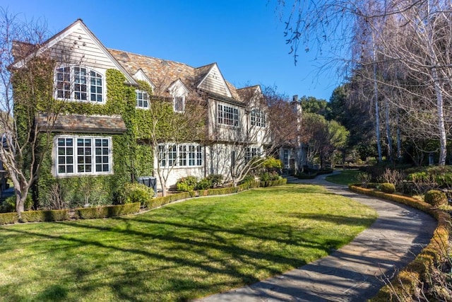 rear view of property featuring a yard