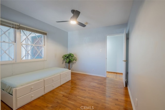 bedroom with ceiling fan and light hardwood / wood-style flooring