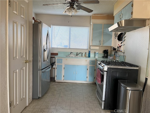 kitchen with range hood, sink, ceiling fan, stainless steel appliances, and a textured ceiling