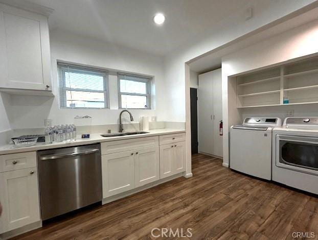 kitchen with sink, white cabinetry, dishwasher, and washing machine and dryer