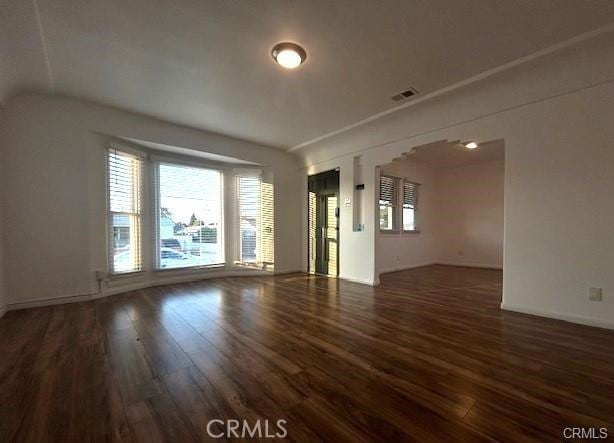 spare room featuring dark hardwood / wood-style flooring