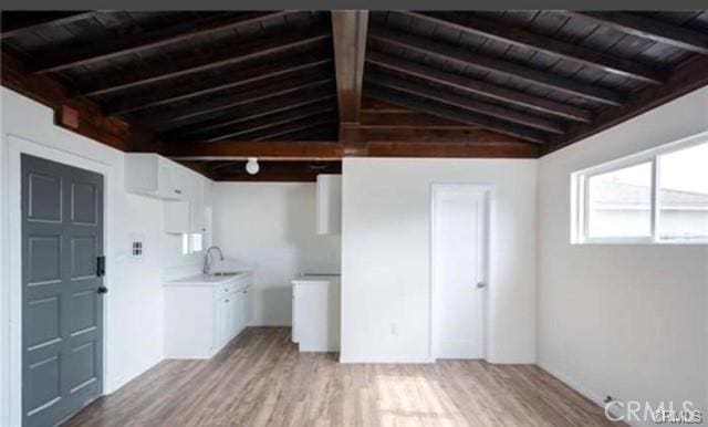 interior space featuring wood ceiling, light hardwood / wood-style flooring, and sink