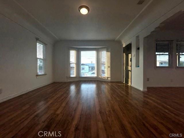 spare room with dark wood-type flooring