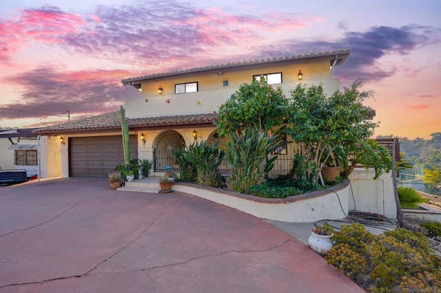 mediterranean / spanish house featuring a garage