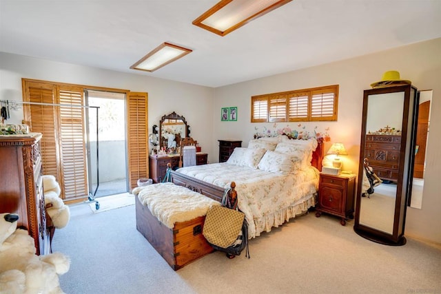 bedroom featuring light carpet and access to outside