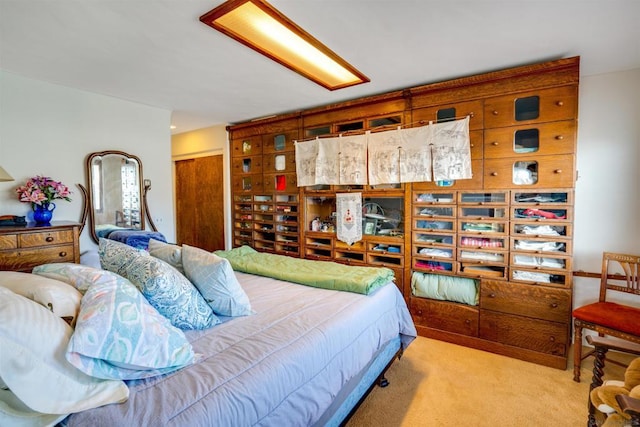 bedroom featuring light carpet and a closet