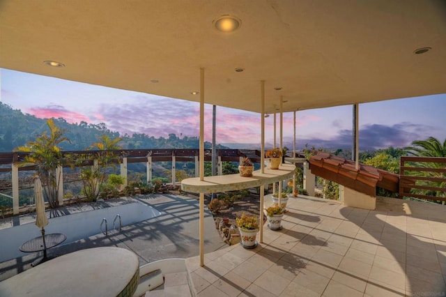 view of patio terrace at dusk