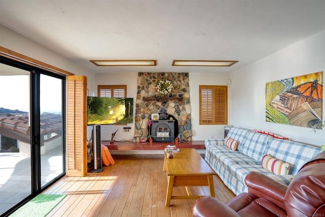 living room with hardwood / wood-style flooring and a wood stove