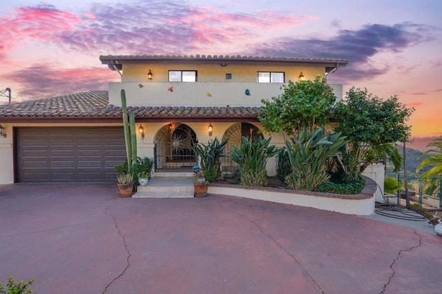 mediterranean / spanish house with a garage