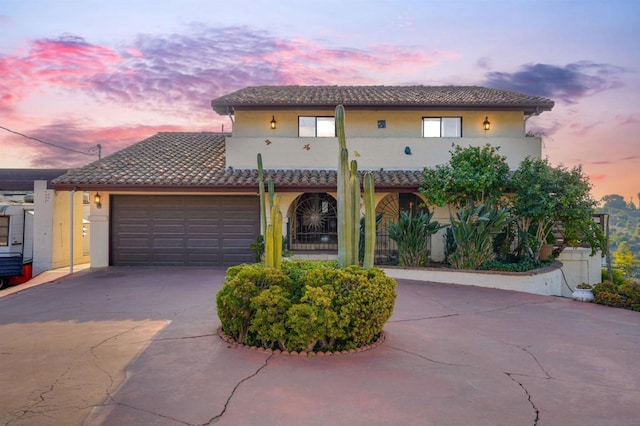 mediterranean / spanish house with a garage