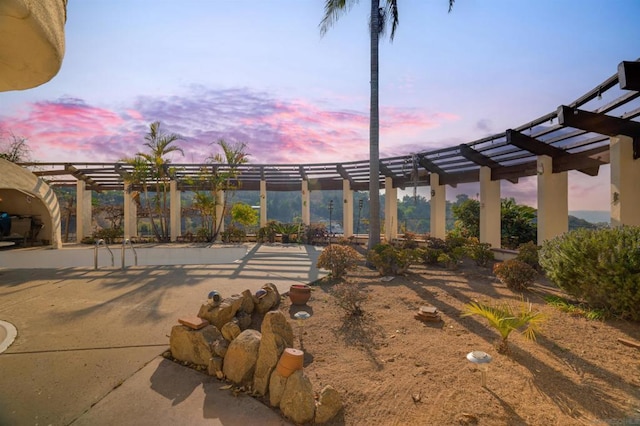 patio terrace at dusk with a pergola