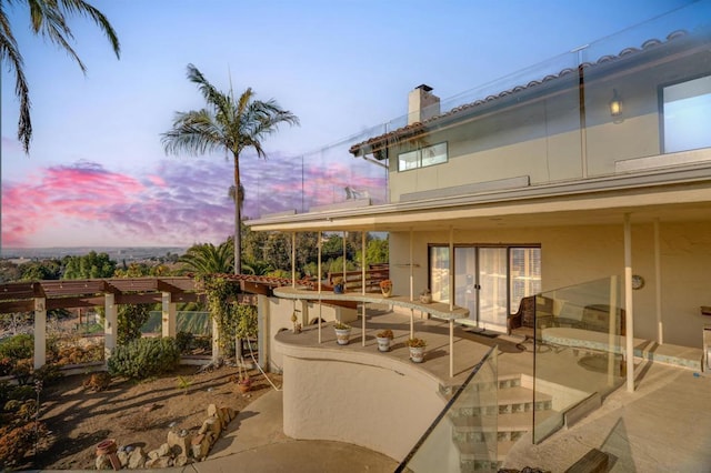 view of patio terrace at dusk