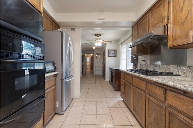 kitchen featuring exhaust hood, light tile patterned flooring, black appliances, and ceiling fan