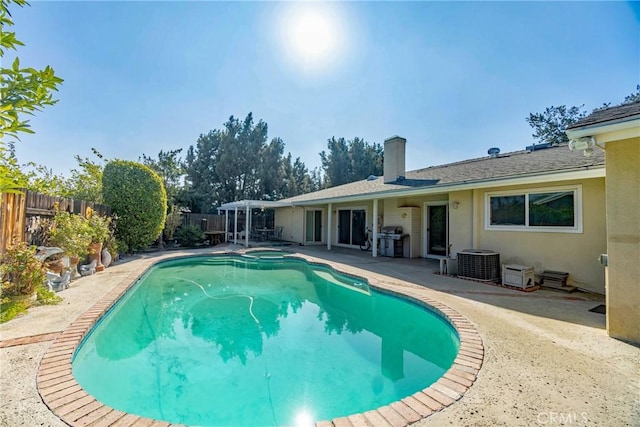 view of pool featuring cooling unit, grilling area, and a patio