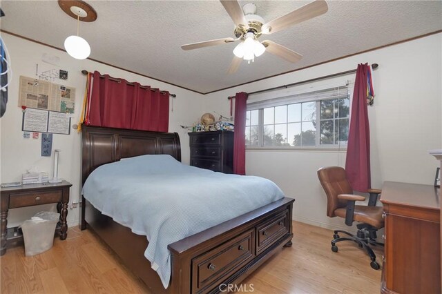 bedroom with light hardwood / wood-style floors, a textured ceiling, and ceiling fan