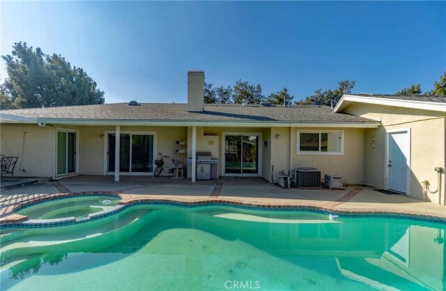 view of pool with an in ground hot tub, a patio, area for grilling, and central AC