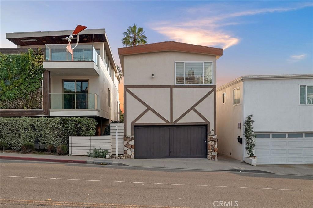 contemporary house featuring a garage and a balcony