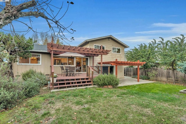 back of property featuring a deck, a yard, a pergola, and a patio