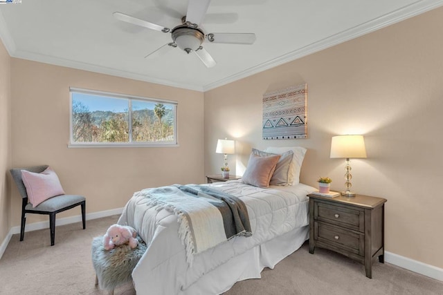 bedroom featuring ceiling fan, light colored carpet, and ornamental molding