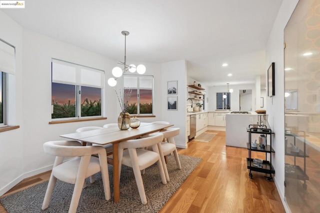 dining space with a chandelier and light wood-type flooring