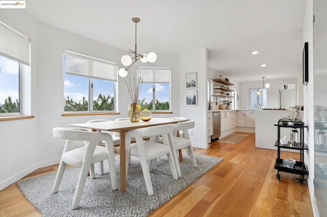 dining room with a chandelier and light hardwood / wood-style flooring