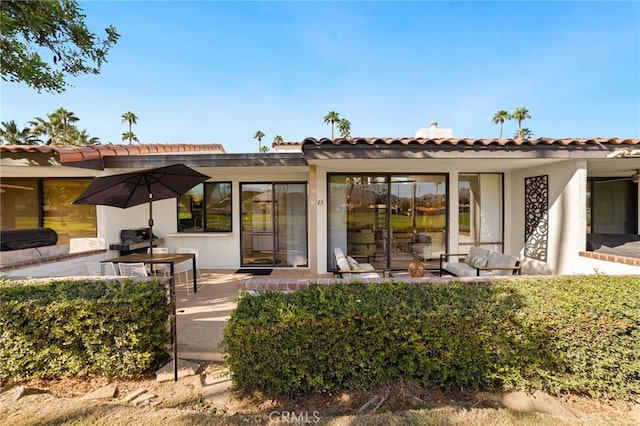 rear view of property featuring a patio area and an outdoor hangout area