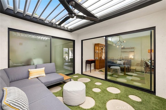 interior space with ceiling fan and vaulted ceiling with skylight