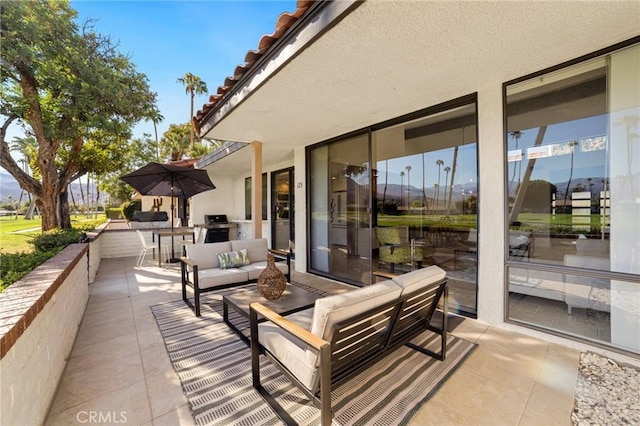 view of patio with an outdoor living space and grilling area