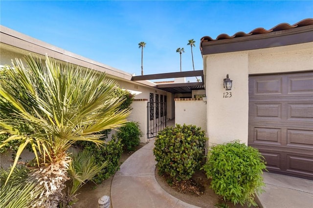 view of exterior entry with a garage