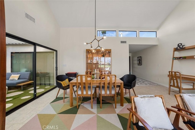 dining area featuring an inviting chandelier and high vaulted ceiling