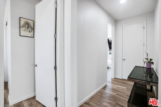 hallway with light hardwood / wood-style flooring