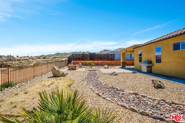 view of yard featuring a mountain view and a patio area