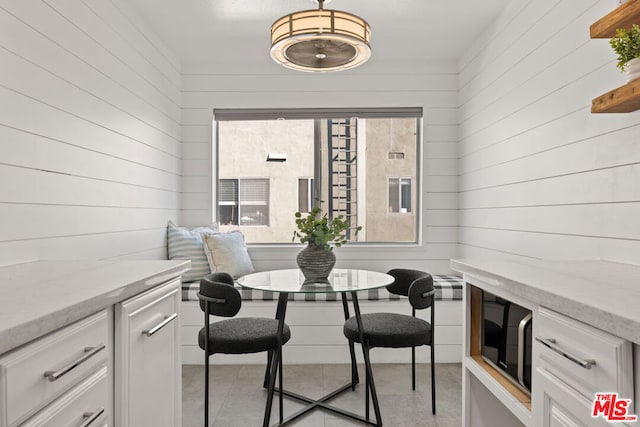 dining area with breakfast area and wooden walls