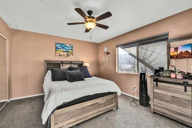 bedroom featuring ceiling fan and dark carpet