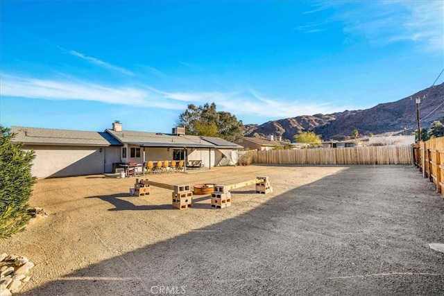 view of yard with a fenced backyard and a mountain view